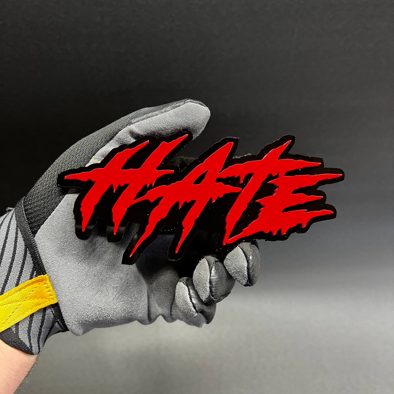 Handmade acrylic HATE word emblem with 3D layered look and aggressive styling.