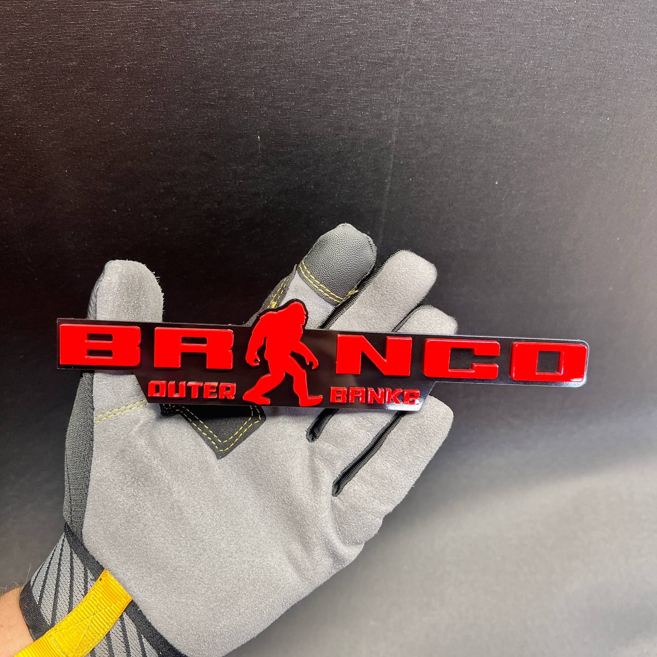 Bronco Outer Banks Bigfoot car badge made in a red and black layered design