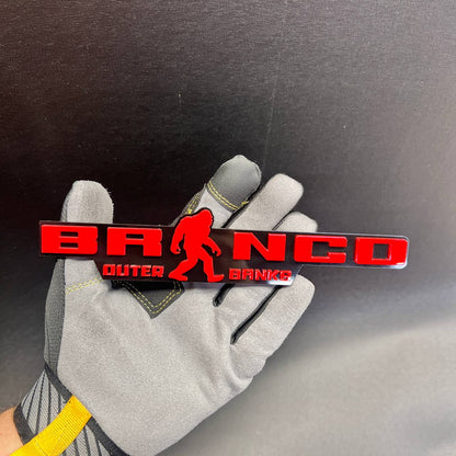 Bronco Outer Banks Bigfoot car badge made in a red and black layered design