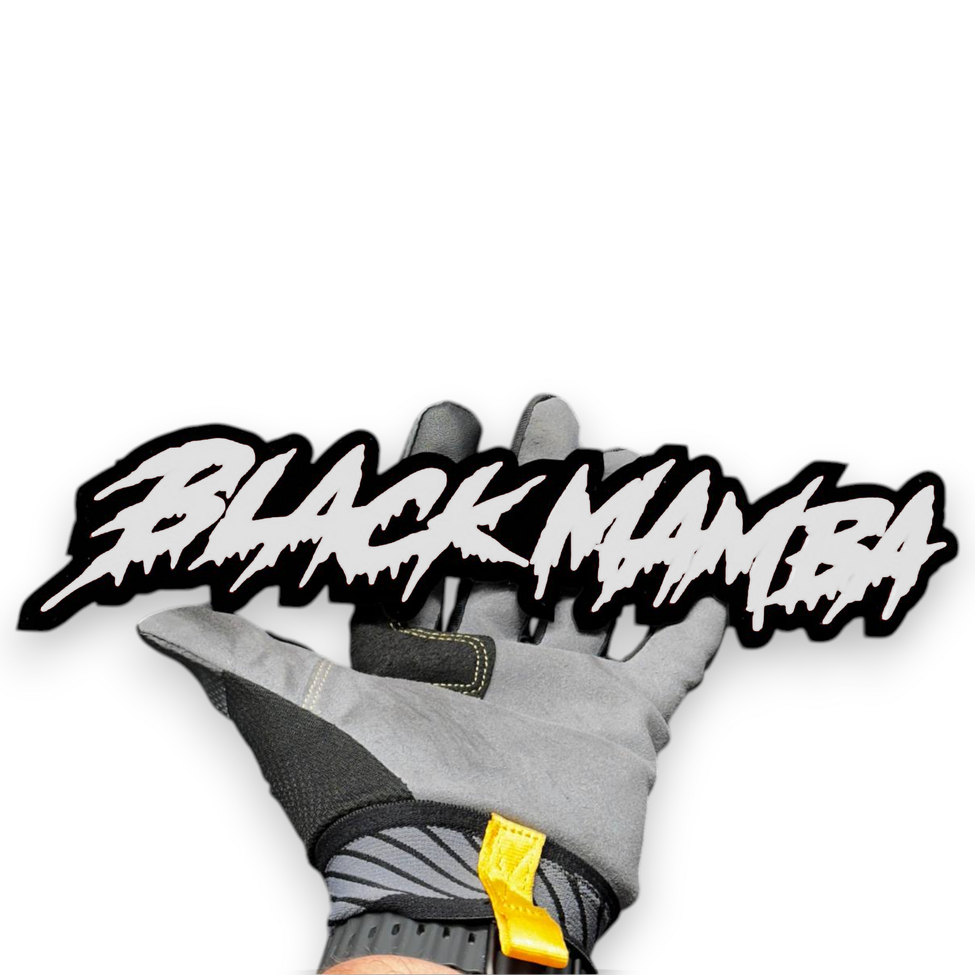 Black Mamba custom text badge shown in hand with red letters and black outline for vehicle exterior.