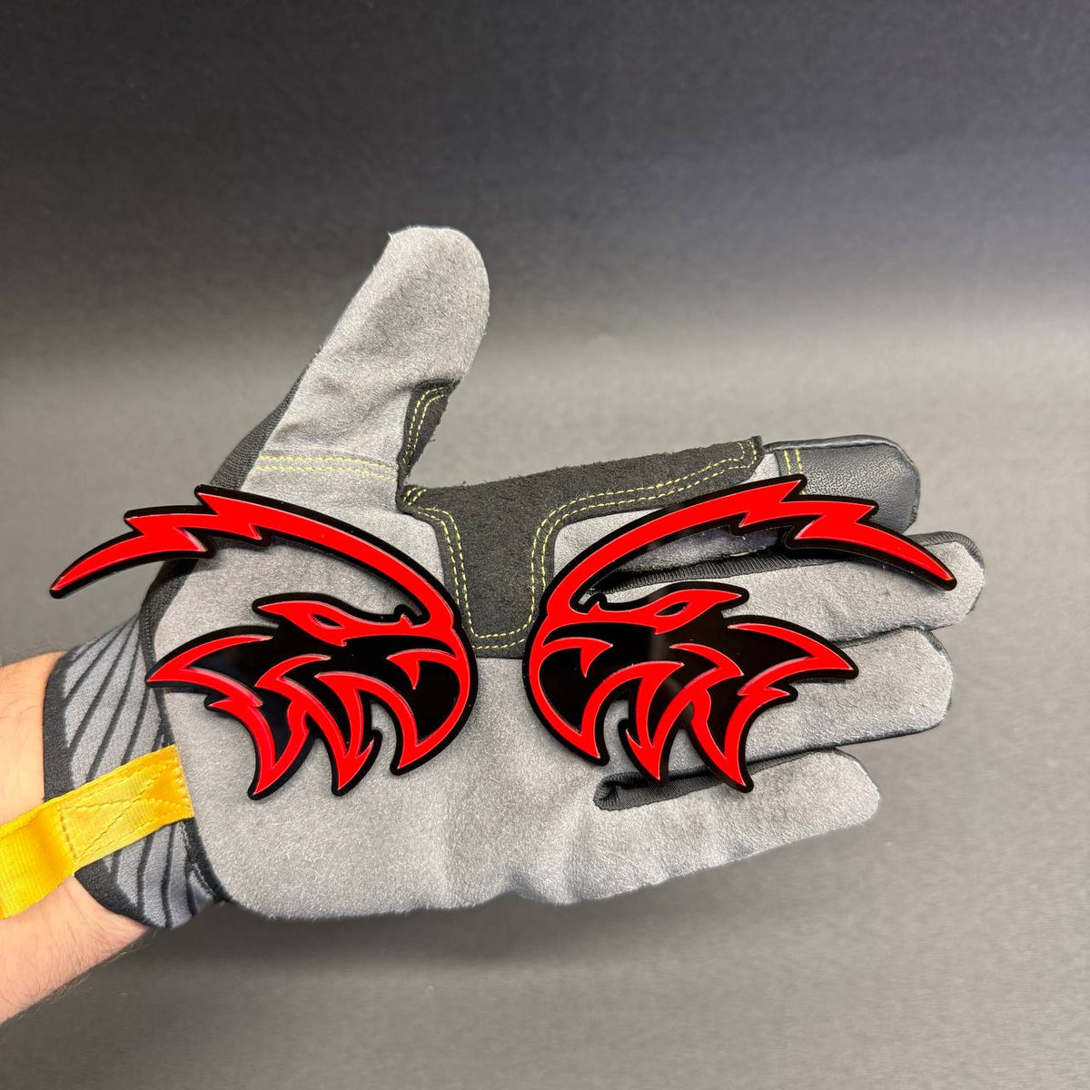 Custom Angry Falcon bird logo car badge in glossy red and black, aftermarket exterior accessory for Jeep Wrangler, Gladiator and SUVs.