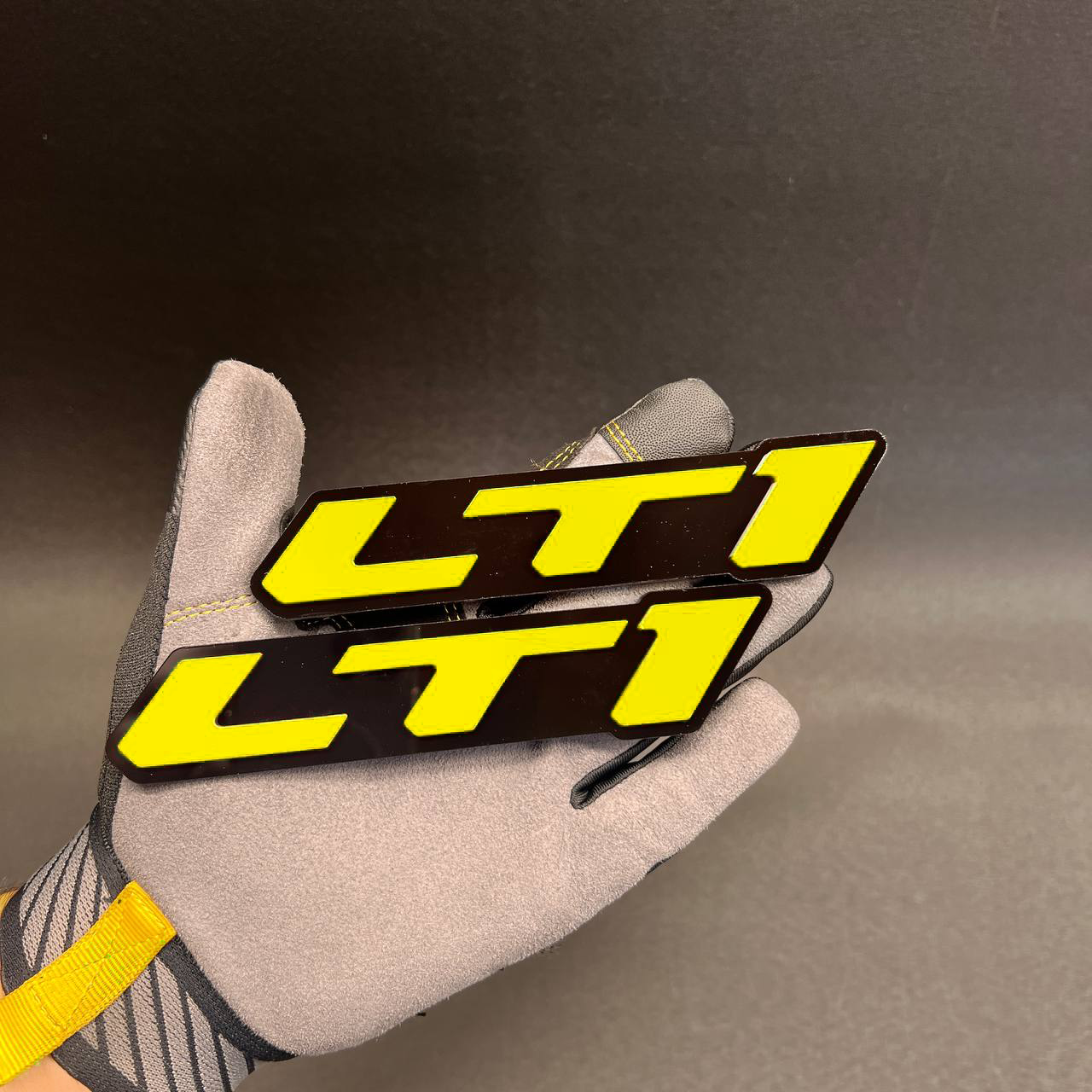 Red LTI lettering badge on black base for car exterior styling