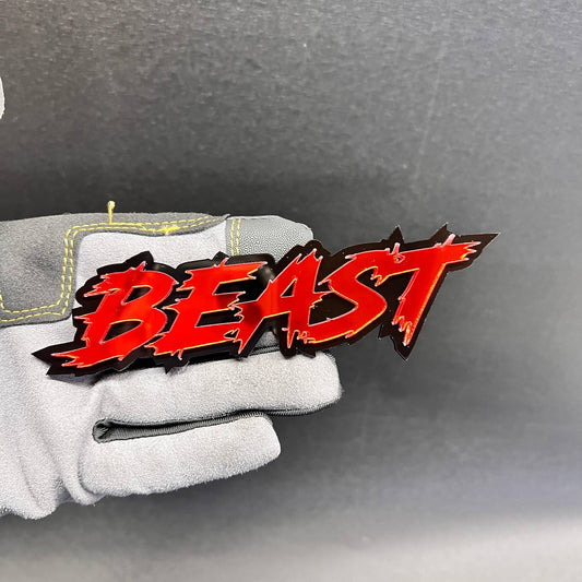 Custom BEAST car badge with red mirror lettering and a black background
