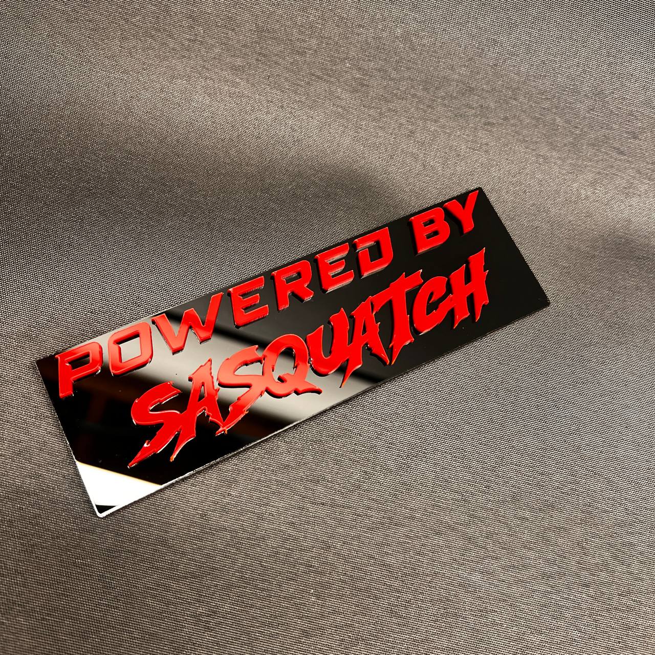 Sasquatch themed car badge fender emblem in red and black design