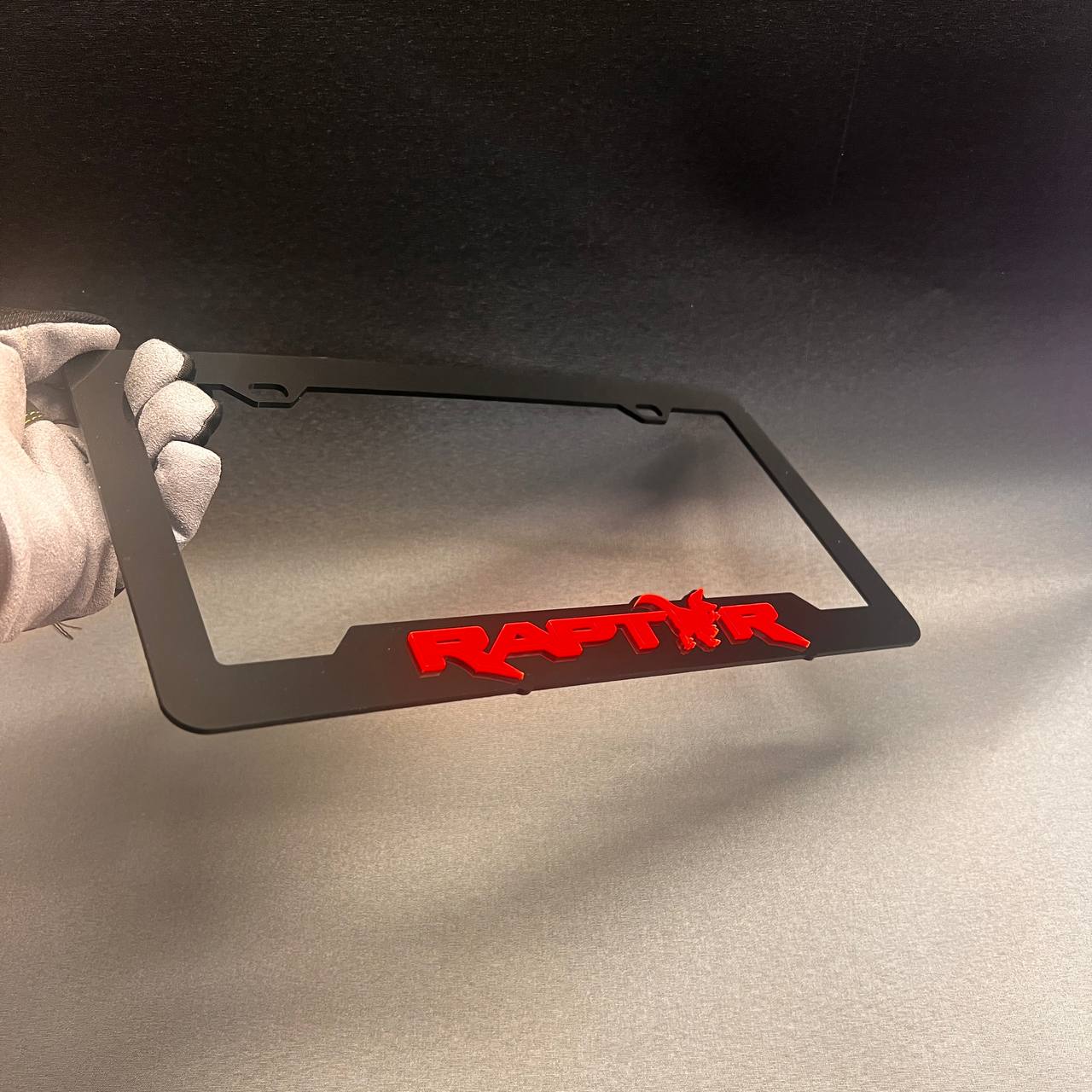 Durable black license plate frame with aggressive Raptor style design