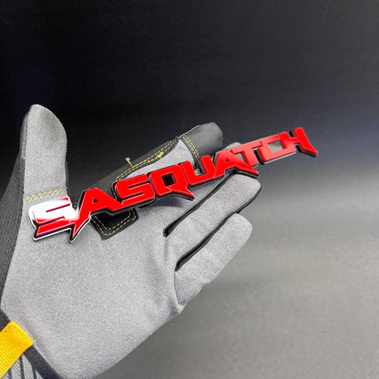 Glossy red Sasquatch auto badge with layered black outline
