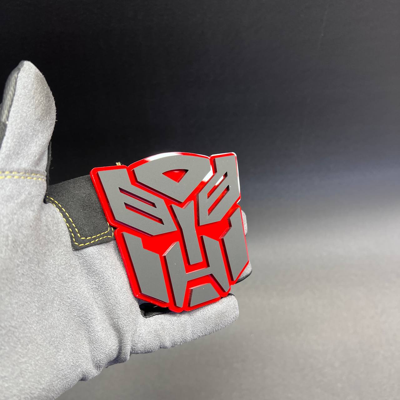 Custom robot head car badge with red outline and silver face details