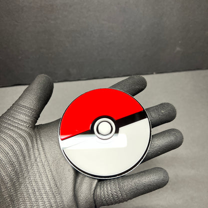 Glossy red white gaming inspired auto badge held in hand
