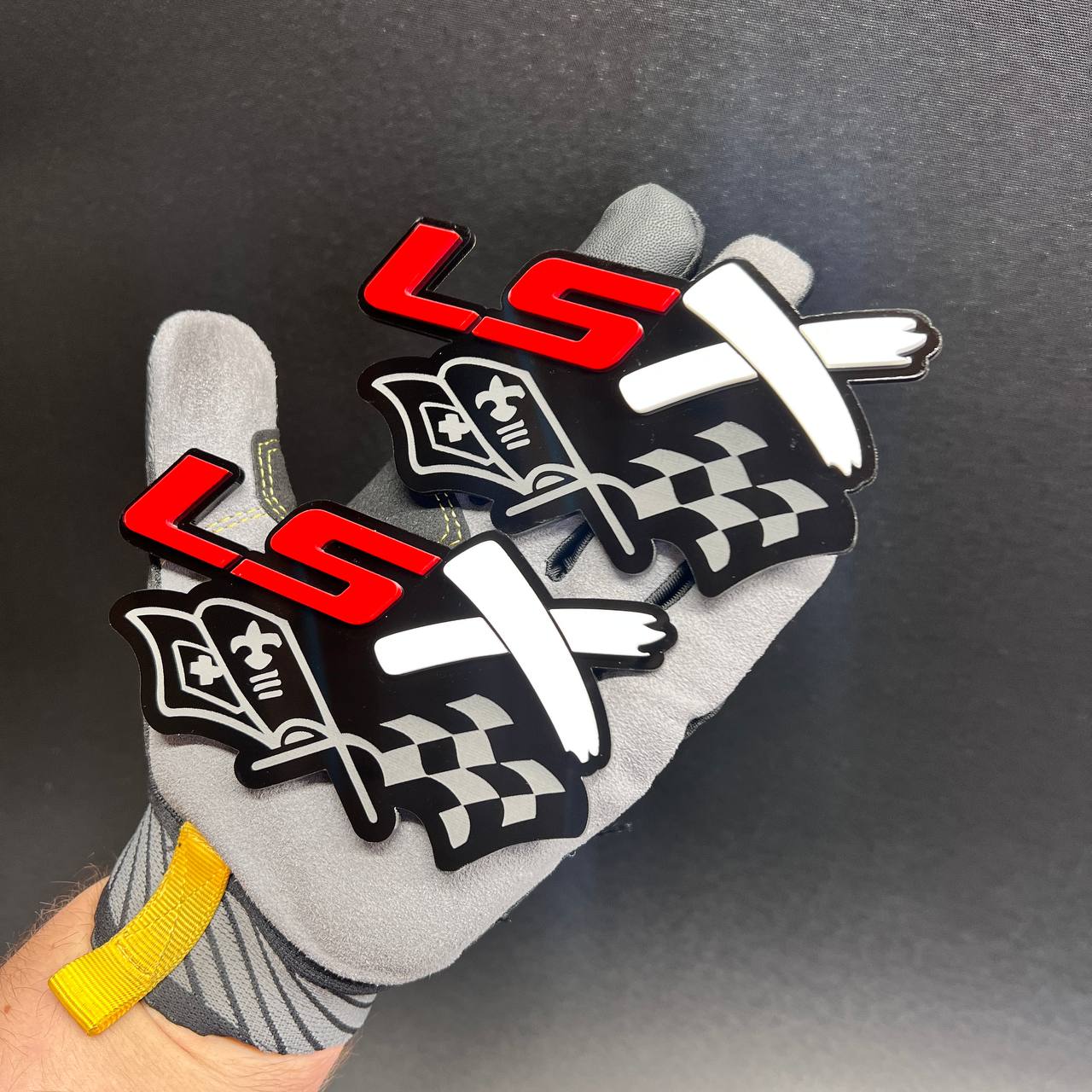 Custom LSX racing flag exterior emblem displayed on a work glove