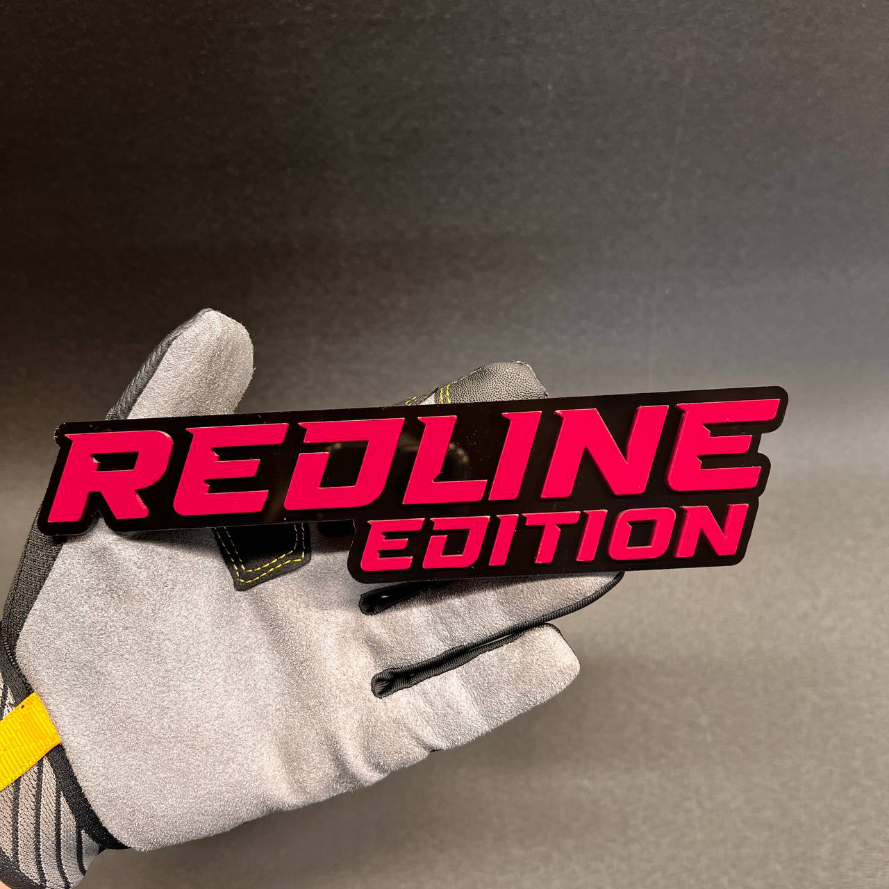 Redline Edition performance style auto badge in red and black color