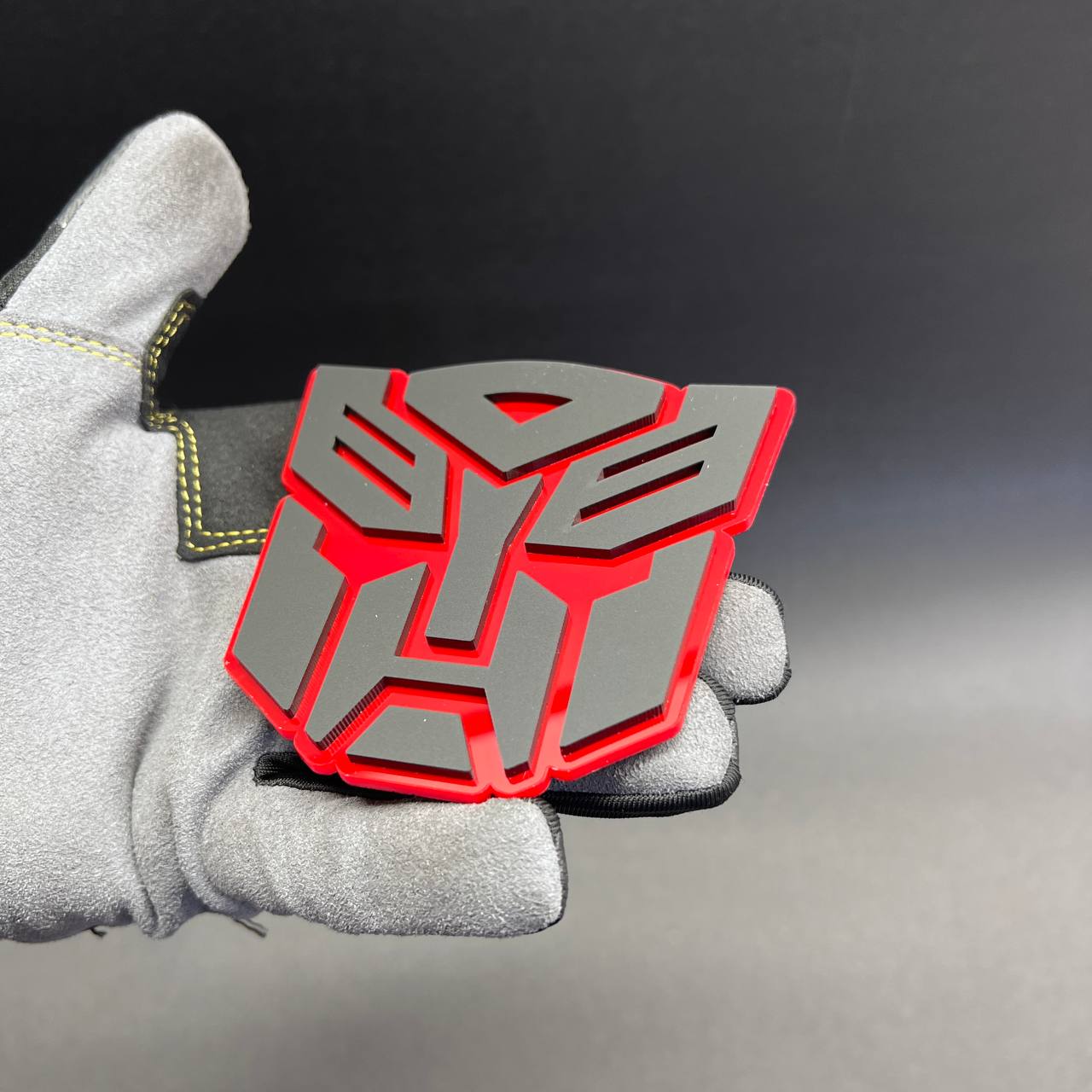 Layered sci-fi robot shield emblem in red and gray for car or truck styling