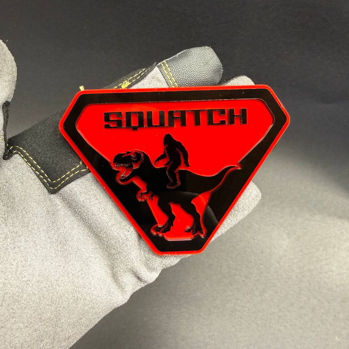 Sasquatch Raptor car badge with Sasquatch riding dinosaur design for off-road vehicles