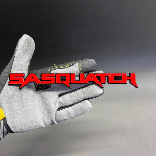 Red and black Sasquatch car badge fender emblem with glossy finish