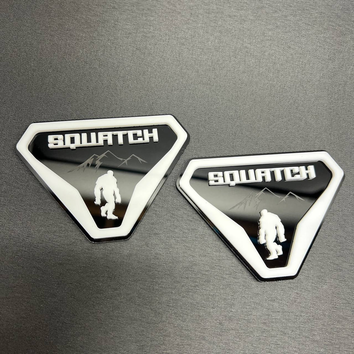 Sasquatch off road car badge with white border and black background