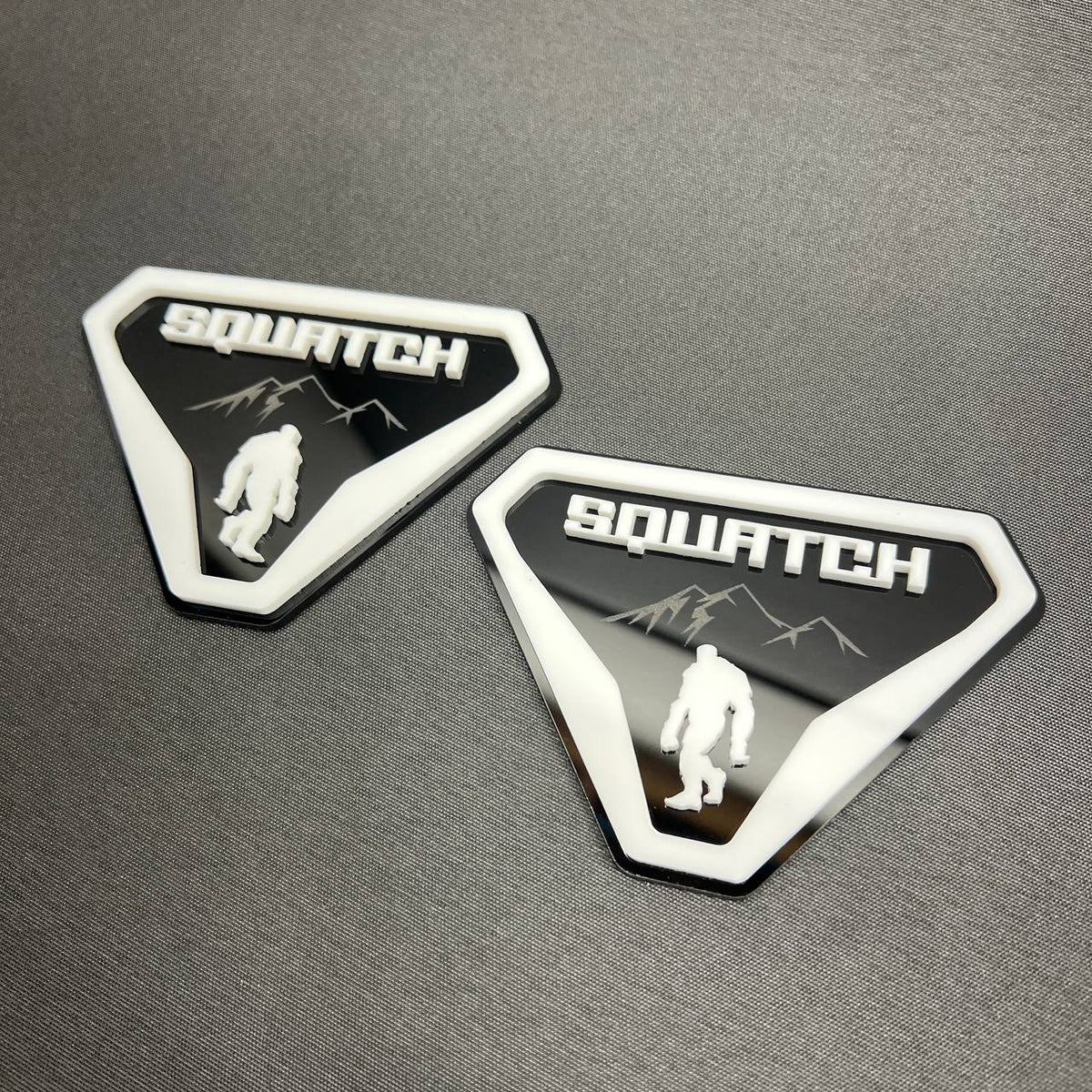White on black Sasquatch 4x4 style car badge emblem