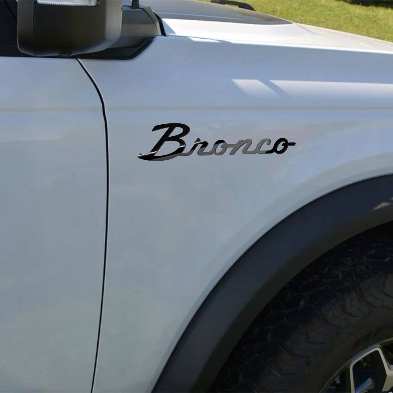 Script-style emblem positioned on SUV fender instalation