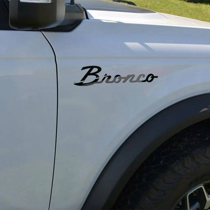 Script-style emblem positioned on SUV fender instalation