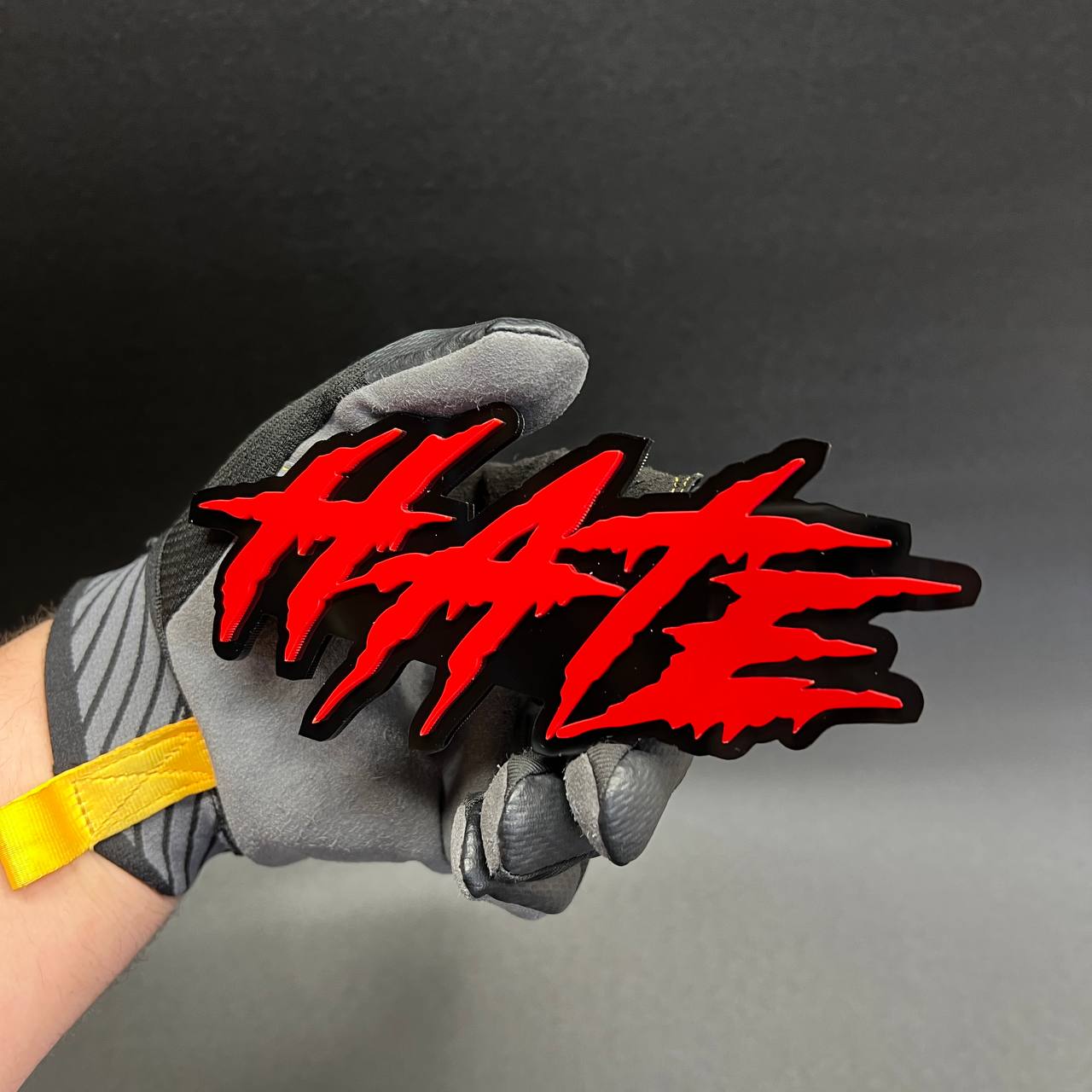 Red HATE lettering badge with black outline for bold car accessory styling.