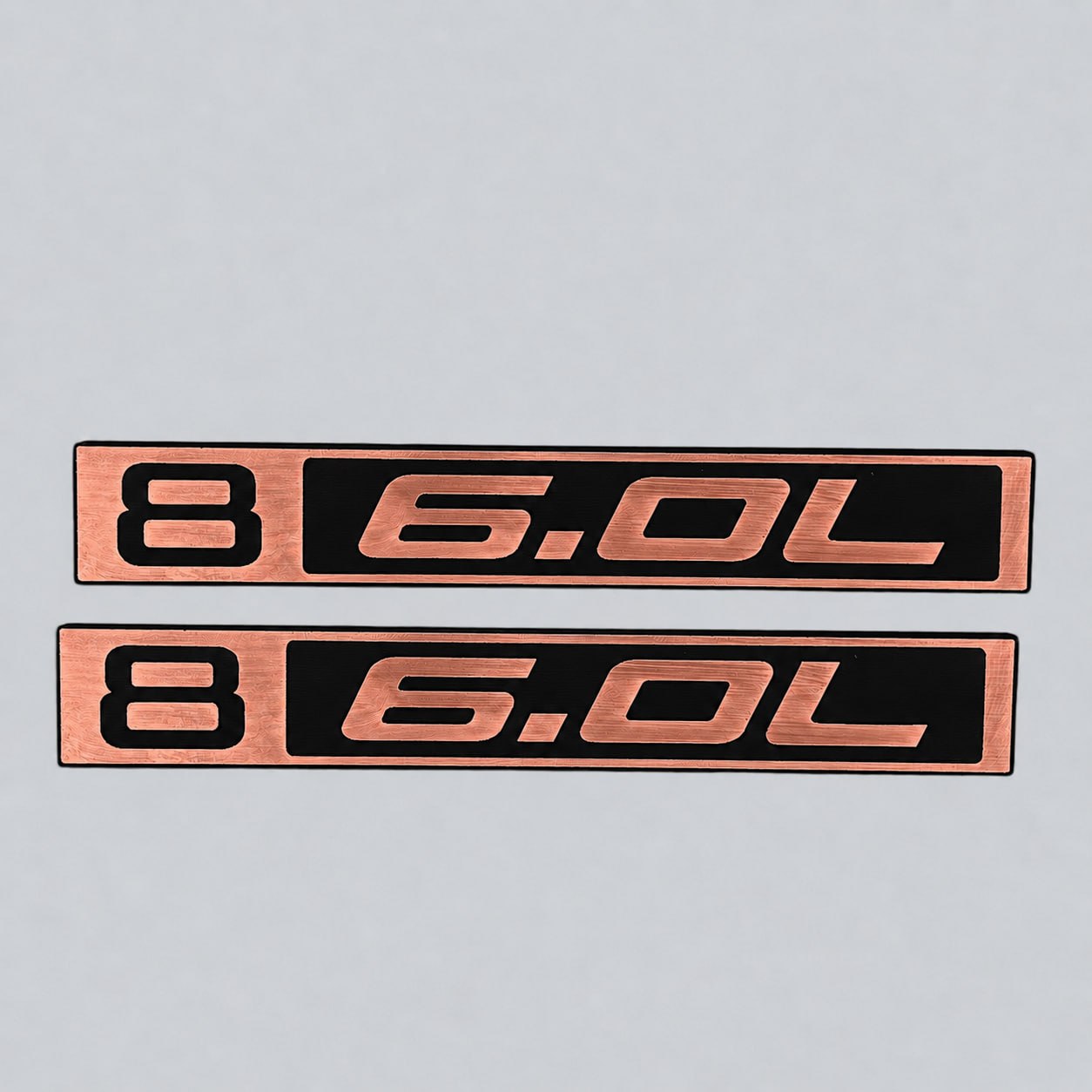 Pair of silver billet style B 6.0L badges for Chevy C10 exterior upgrade.