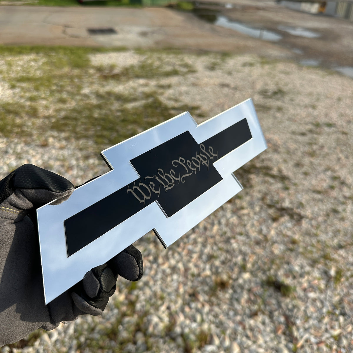 Chevy truck hitch cover featuring a gold Autobot emblem on silver Bowtie design