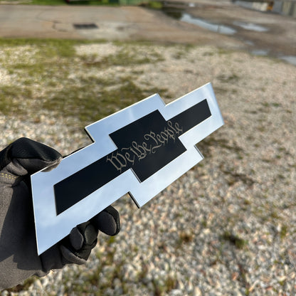 Chevy truck hitch cover featuring a gold Autobot emblem on silver Bowtie design
