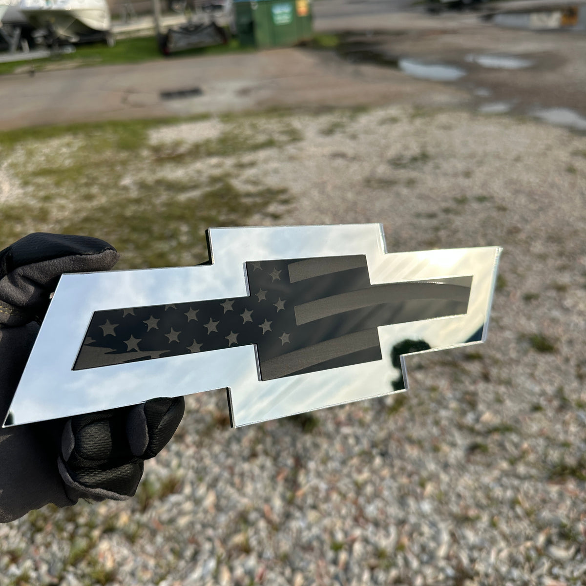 Chevy Bowtie automotive emblem with engraved flag artwork in black and silver
