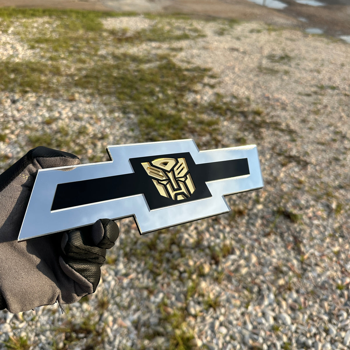 Silver Chevy Bowtie custom badge with black center and gold Autobot logo