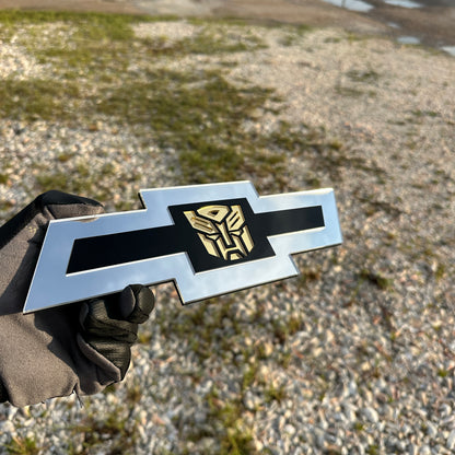 Silver Chevy Bowtie custom badge with black center and gold Autobot logo