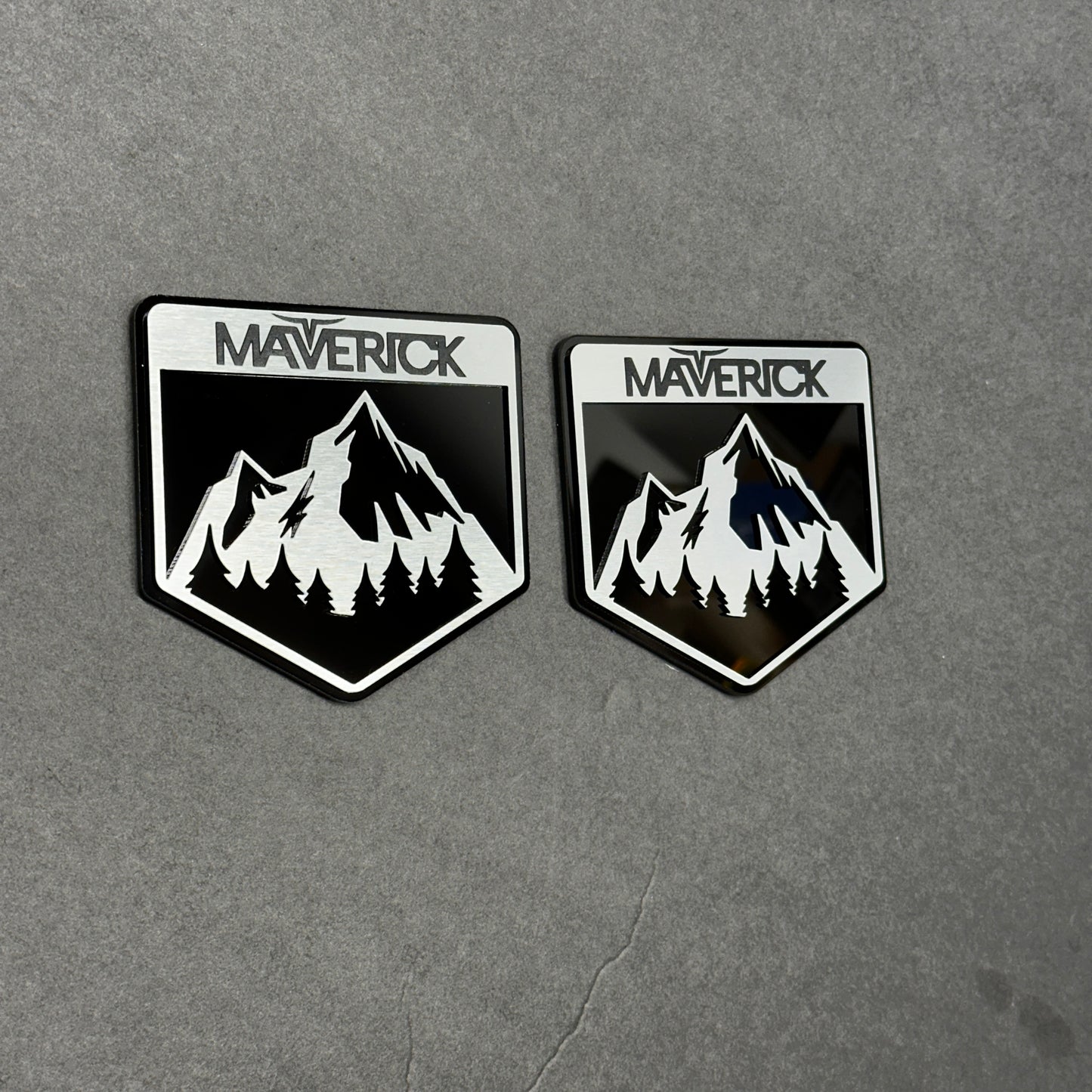 Brushed silver and black Maverick  badge with mountain design