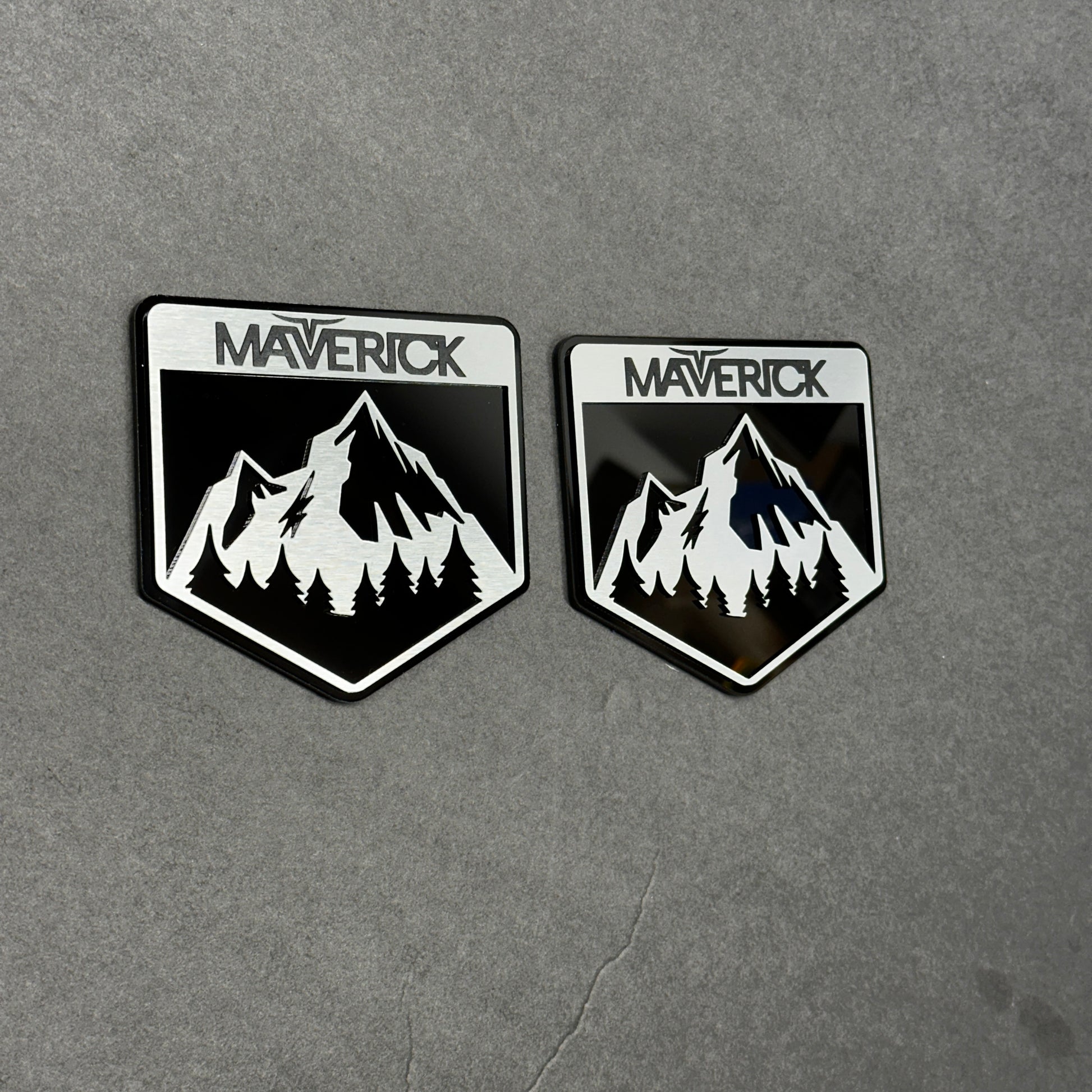 Brushed silver and black Maverick  badge with mountain design