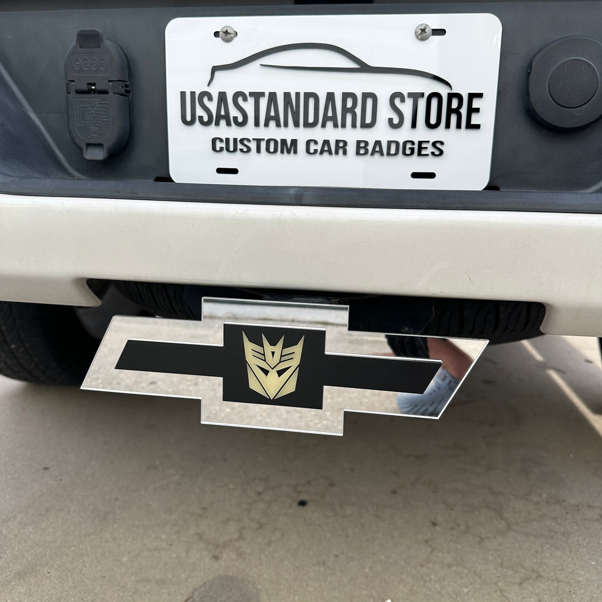Silver Bowtie Chevrolet hitch emblem with Decepticon logo for custom rear styling
