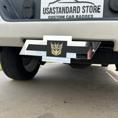 Chevy emblem silver glow in the dark Decepticon hitch cover mounted on a truck receiver