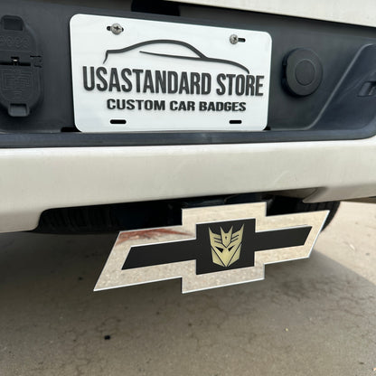 Silver Chevy hitch cover featuring a centered Decepticon emblem