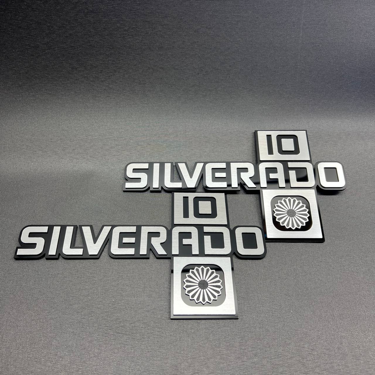 Black and silver Silverado 10 car emblem set