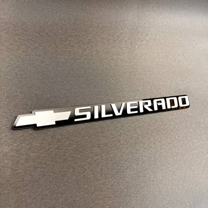 Black and silver Chevy Silverado bowtie tailgate badge for truck exterior customization
