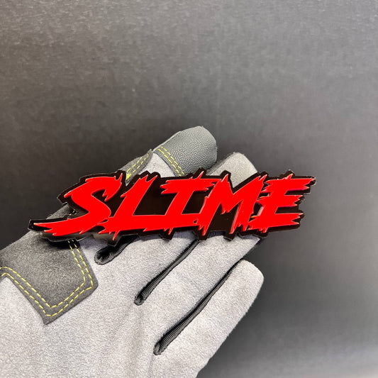 Red SLIME car badge fender emblem with a glossy black background
