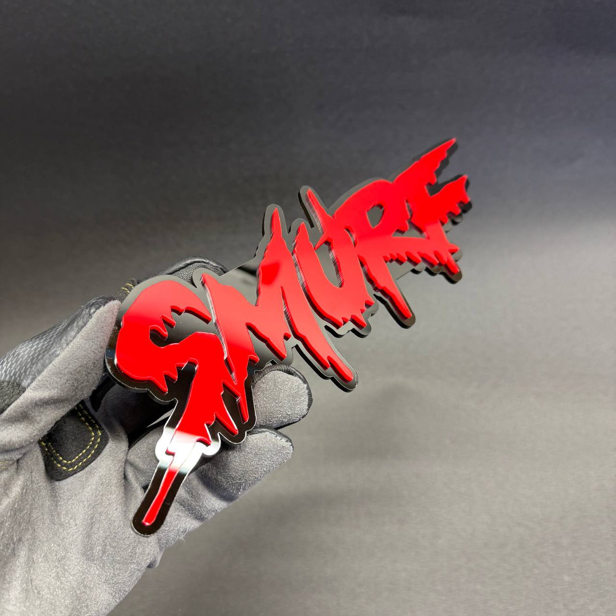 SMURF custom text tailgate emblem featuring bold red street-art letters and black outline for Toyota Tacoma and Tundra truck styling.