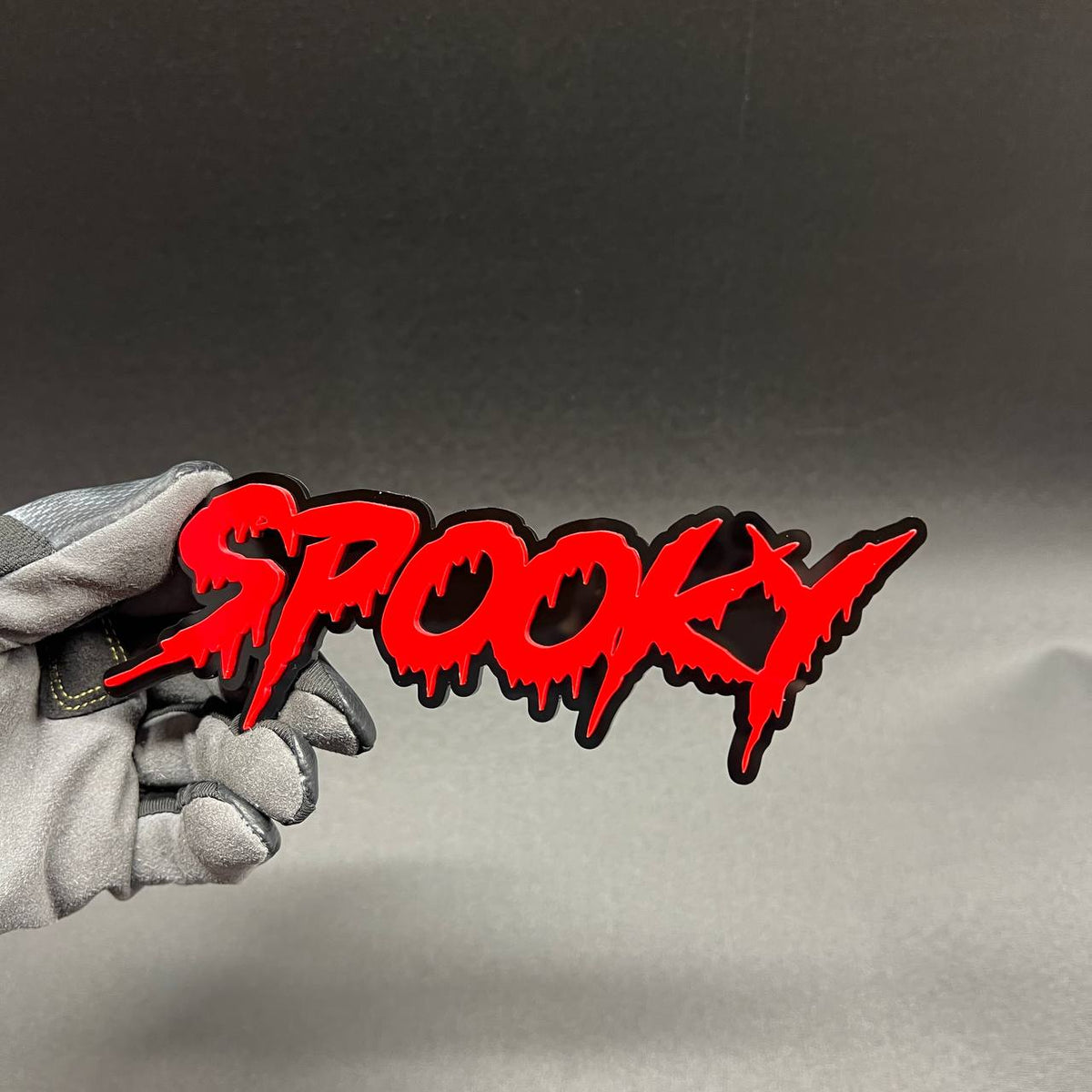 Spooky Halloween car badge with dripping red text and black background for vehicle fender styling