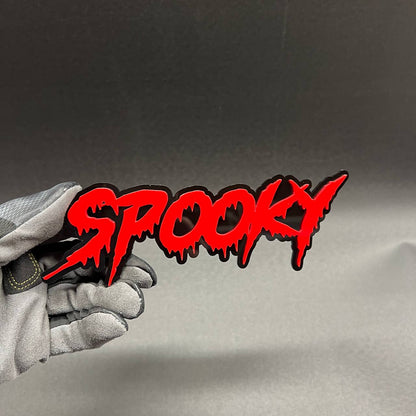 Spooky text car badge in red and black with dripping horror style lettering for custom vehicle exterior