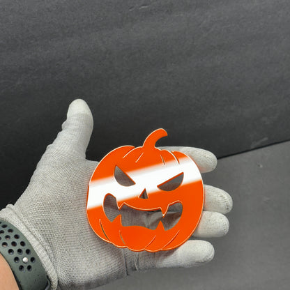 Spooky pumpkin auto badge with star eyes and sharp teeth design