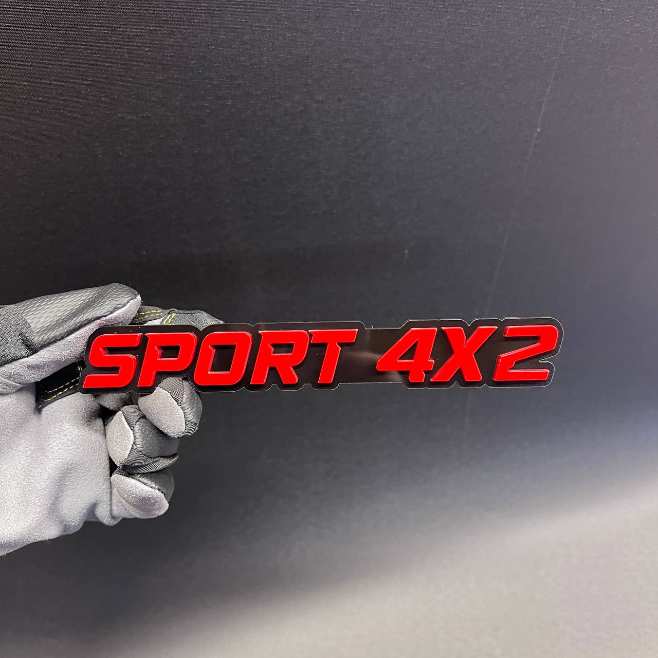 SPORT 4x2 red and black car badge fender emblem with raised 3D style lettering.