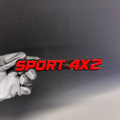 SPORT 4x2 red and black car badge fender emblem with raised 3D style lettering.