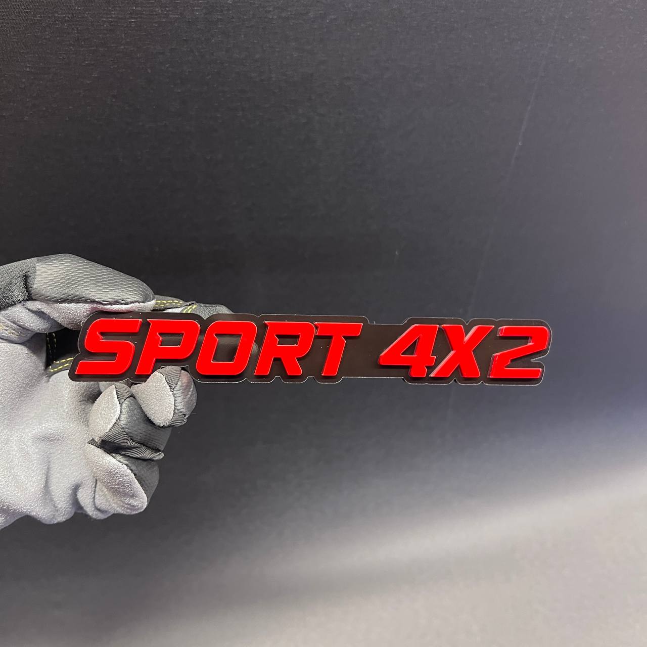 SPORT 4x2 vehicle fender or tailgate emblem in red and black finish.