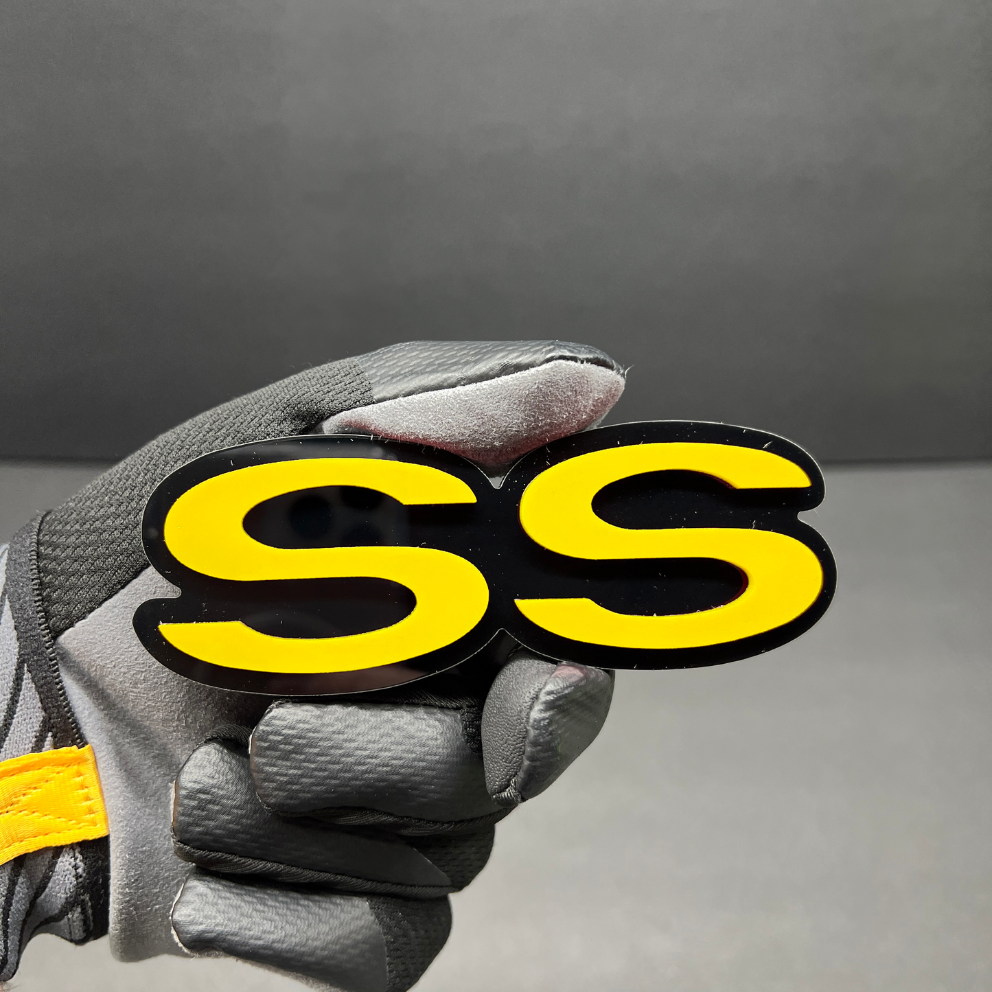 Custom SS fender badge with 3M adhesive backing for vehicles.