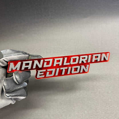 Mandalorian Edition custom automotive emblem with two-line lettering and red reflective finish, decorative fender badge for Dodge Ram 1500 and 2500.