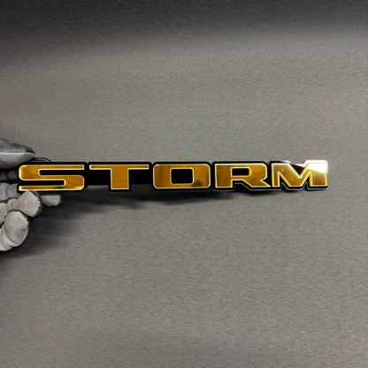 Gold STORM car badge with black background, custom automotive emblem for Ford F150, Chevy Silverado, GMC Sierra and RAM trucks.