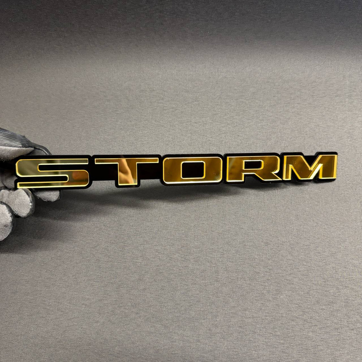 STORM gold and black custom car emblem, personalized text badge for Ford Mustang, F150, Dodge Charger, RAM, Chevy and GMC.