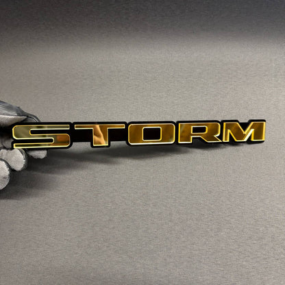 STORM gold and black custom car emblem, personalized text badge for Ford Mustang, F150, Dodge Charger, RAM, Chevy and GMC.