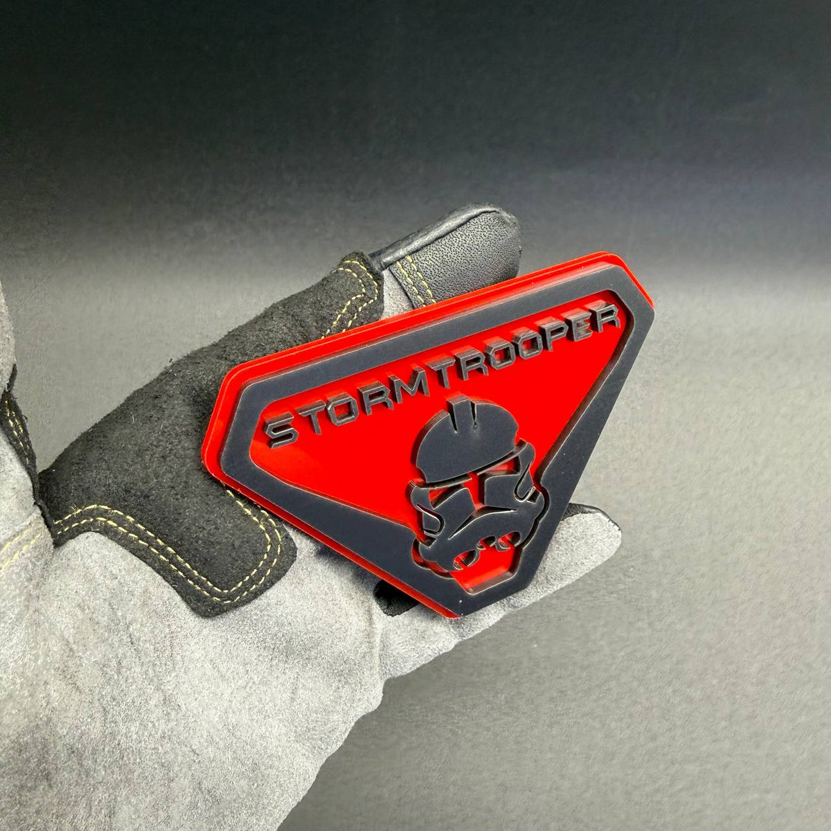 Custom Stormtrooper car emblem with black raised design and red base for Dodge RAM 1500, 2500, 3500 and other pickup trucks.
