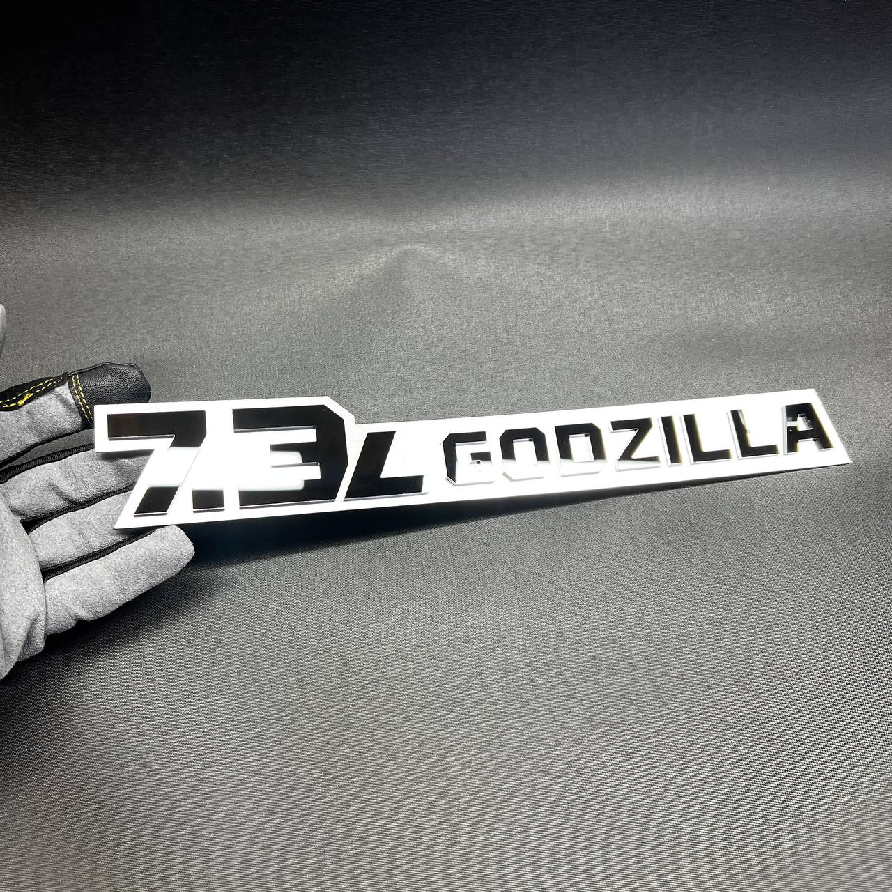 Custom 7.3L Godzilla V8 truck emblem with aggressive styling for Super Duty accessory listing.